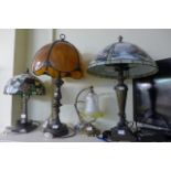 Three brass table lamps and shades, two in the Art Nouveau/Macintosh style, and a further brass