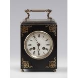 TRAVEL CLOCK, EARLY 20TH CENTURY

case in ebonized wood and white enamel face. Trimming and