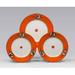 THREE PLATES IN PORCELAIN, PROBABLY SICILIA, LATE 19TH CENTURY

white and orange glazing, with