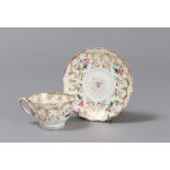CUP AND SAUCER IN PORCELAIN, 19TH CENTURY

glazed in white, polychrome and gold, with motif of