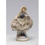 FIGURE OF DAME IN PORCELAIN, 20TH CENTURY

polychrome glazing, the figure is dancing in a large