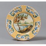 SMALL PLATE IN MAIOLICA, CASTELLI, 20TH CENTURY

polychrome glazing, painted landscape in well.