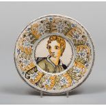 PLATE IN MAIOLICA, CASTELLI, PROBABLY BUSSI, 17TH CENTURY

white, ochre and green glazing, with