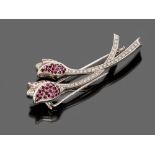 BROOCH

in white gold 18 kt., shaped as blossom with

rubies and diamonds.

Length cm. 7, rubies ct.