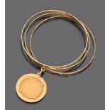 BRACELET in yellow gold 18 kts., to three you look for with pendant coin pound engraved with figures