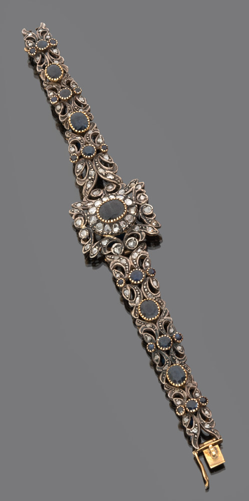A BEAUTIFUL SEMIRIGID BRACELET in gold and silver, embellished by rose-cut diamond and faceted