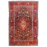 KASHAN CARPET, FIRST HALF OF 20TH CENTURY with red background medallion and secondary motifs