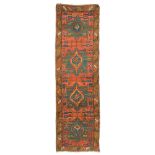 KAZAK RUNNER CARPET, LATE 19TH CENTURY medallions on green base and secondary motifs with leaves,