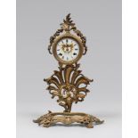 GILDED METAL TABLE CLOCK, LATE 19TH CENTURY with uppercut and leaves base. Quadrant in white