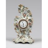 CERAMIC CLOCK, EARLY 20TH CENTURY white enamel and polychrome, with decor in clumps of flowers and