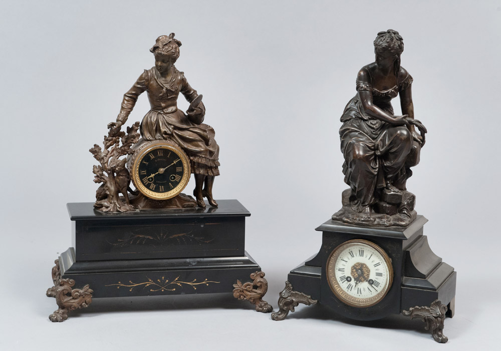 TWO TABLE CLOCKS, PROBABLY FRANCE 19TH CENTURY with figures of female allegories in burnished metal.