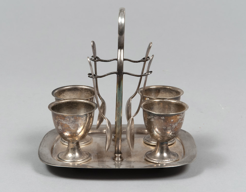 SILVERED METAL EGG-CUP, ENGLAND SECOND HALF 19TH CENTURY with four egg-cups and four teaspoons.