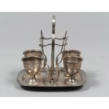 SILVERED METAL EGG-CUP, ENGLAND SECOND HALF 19TH CENTURY with four egg-cups and four teaspoons.