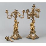 A PAIR OF GILDED BRONZE CANDLESTICK, 19TH CENTURY with five arms, garnished with seated figure of