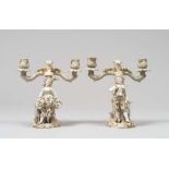 A PAIR OF BISCUIT CANDELABRA, EARLY 20TH CENTURY to white enamel and gold with braccia to ramages