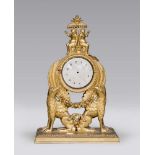 GILDED WOOD CLOCK, EARLY 19TH CENTURY with graven box to two classical figures on the hat. Base to