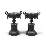 A PAIR OF BURNISHED BRONZE CUPS, 19TH CENTURY with chisel of classical taste. Base in black marble