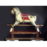 COLLINSON ROCKING HORSE. A post-1940 dappled rocking horse by Collinson of Liverpool. Length 143cm.