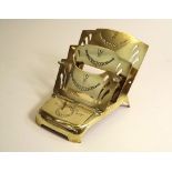 BRASS INKWELL. An Edwardian brass folding letter rack, with integral inkwell.