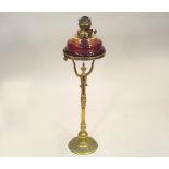 OIL LAMP. A tall 19th century brass oil lamp with clear glass fount. Height 85cm.