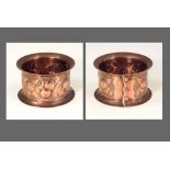 NEWLYN COPPER. A Newlyn napkin ring decorated with fruit. Stamped 'NEWLYN'. Diameter 5.5cm.