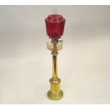 OIL LAMP. A 19th century tall oil lamp, with clear glass fount & cranberry shade.