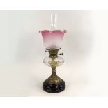 OIL LAMP. A Victorian oil lamp with facet-cut glass fount & etched shade. Height 55cm.