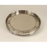 ARTS & CRAFTS TRAY. An Arts & Crafts polished tin galleried tray, possibly Scottish. Diameter 29cm.