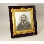 PORTRAIT FRAME. A late Victorian 'acorn ormolu' portrait frame, set within a glazed case. 47 x 41cm.