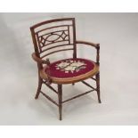 LOW CHAIR. An Edwardian walnut low chair with woolwork upholstered seat. Height 70cm.