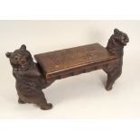 MUSIC BOX. A Swiss music box (lacking movement) supported by two carved bears with glass eyes.