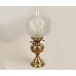 OIL LAMP. A brass oil lamp with etched shade. Height 50cm.