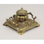 BRASS INKWELL. A 19th century ornate cast brass inkwell, 18 x 17cm.