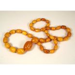 AMBER. A good long string of amber beads. Largest bead 3cm. Approx. 75g.