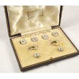 DRESS SET. A set of four 9ct. gold sapphire set dress buttons & matching studs, cased.