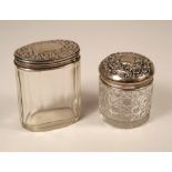 TOILET JARS. Two silver mounted toilet jars.