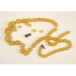 AMBER. A string of pale yellow amber beads & a few loose beads. Largest bead 2cm. Approx. 45g.