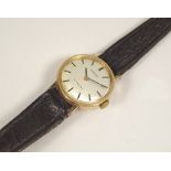 GOLD WATCH. A lady's 9ct. gold cased Tissot wristwatch with leather strap.