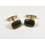 GOLD CUFFLINKS. A pair of 9ct. gold cufflinks, set a green hardstone.