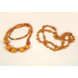 AMBER ETC. A 1930's amber necklace & an amber coloured necklace.