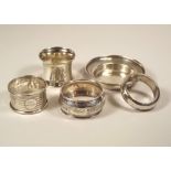 NAPKIN RINGS ETC. Four various napkin rings & a small pin tray.