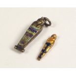 ENAMELLED CHARM. An enamelled sarcophagus charm, with contents.