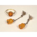 AMBER. A pair of amber pendant ear drops & a 9ct. gold amber set ring. (ring a.f.