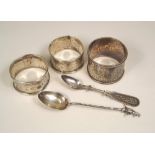 NAPKIN RINGS ETC. Three napkin rings & two spoons.