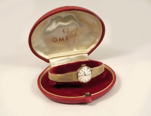 GOLD WATCH. A lady's 9ct. gold cased Omega wristwatch & tapering strap. Original box.