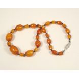 AMBER. An amber bead necklace. Largest bead length 2.2cm. Approx. 25g.