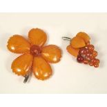 AMBER. Two early 20th century carved amber brooches. Largest 6.5.x 6cm.