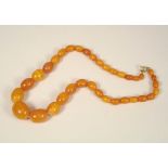 AMBER NECKLACE. An amber bead necklace. Largest bead length 2cm. Approx. 28g.