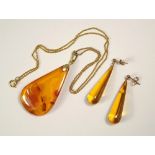 AMBER. A modern 'amber' pendant & a pair of pendant 'amber' earrings on 9ct. gold fittings.