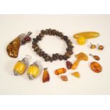 AMBER. A raw amber chip bracelet, a modern silver mounted amber pendant etc.